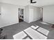 Bright living room featuring neutral paint, plush carpet, and modern ceiling fan, adjacent to laundry area at 102 Plummer Ave, Bargersville, IN 46106