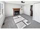 Living room featuring a fireplace, neutral paint, ceiling fan, and new carpeting at 102 Plummer Ave, Bargersville, IN 46106