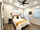 Cozy bedroom featuring a queen bed, ceiling fan, barn door accent, and natural light at 1042 Nelson Ave, Indianapolis, IN 46203