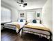 Bright bedroom with two beds, ceiling fan, and plenty of natural light at 1042 Nelson Ave, Indianapolis, IN 46203