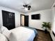 Comfortable bedroom featuring a ceiling fan, television, wood floors, and modern decor at 1042 Nelson Ave, Indianapolis, IN 46203