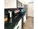 Modern kitchen with stainless steel appliances, black countertop, and sleek white cabinets at 1042 Nelson Ave, Indianapolis, IN 46203