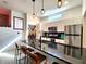 Bright kitchen features an island with bar stool seating, black countertop, and modern stainless steel appliances at 1042 Nelson Ave, Indianapolis, IN 46203