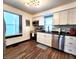 Modern kitchen with stainless steel appliances, stylish countertops, backsplash, and new flooring at 1042 Nelson Ave, Indianapolis, IN 46203