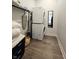Functional laundry room with stacked washer/dryer and storage at 1042 Nelson Ave, Indianapolis, IN 46203