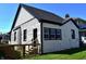 Back of house featuring updated landscaping, black trim and a well-kept lawn at 1042 Nelson Ave, Indianapolis, IN 46203