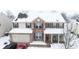 Aerial shot showcasing a snow-covered two-story home with a brick and siding exterior, plus a two-car attached garage at 1136 Meriman Dr, Greenwood, IN 46143