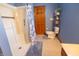 Well-lit bathroom with a white shower and blue walls, creating a refreshing ambiance at 1136 Meriman Dr, Greenwood, IN 46143