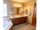 Bathroom featuring a soaking tub with tile surround, double vanity, and tiled floors at 1136 Meriman Dr, Greenwood, IN 46143