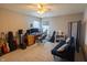 Spacious carpeted bedroom with ceiling fan, futon, and guitars at 1136 Meriman Dr, Greenwood, IN 46143