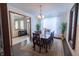 Elegant dining room boasting hardwood floors, a chandelier, and a table set for six, adjacent to another room at 1136 Meriman Dr, Greenwood, IN 46143