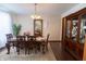 Formal dining room with hardwood floors, a large china cabinet, and a dining table set for six at 1136 Meriman Dr, Greenwood, IN 46143
