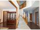 Bright foyer featuring a staircase with wood railings and a large china cabinet, leading to other rooms at 1136 Meriman Dr, Greenwood, IN 46143