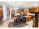 Open kitchen with wood cabinetry, tile floors, and a marble-topped dining table at 1136 Meriman Dr, Greenwood, IN 46143