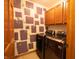 Laundry room with updated washer and dryer, cabinets, and decorative wallpaper at 1136 Meriman Dr, Greenwood, IN 46143