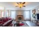 Comfortable living room with hardwood floors, a fireplace, large windows, and a ceiling fan for added comfort at 1136 Meriman Dr, Greenwood, IN 46143