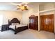 Cozy bedroom featuring a ceiling fan, neutral carpet, and elegant wood furniture at 1136 Meriman Dr, Greenwood, IN 46143