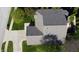 Aerial view of a home with a gray roof, spacious driveway, and surrounding greenery in a residential area at 1232 Severn Ct, Greenwood, IN 46142