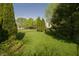 Lush backyard featuring a well-maintained lawn and mature trees, creating a private outdoor space at 1232 Severn Ct, Greenwood, IN 46142