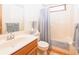Bright bathroom with a cream-colored tub/shower, oak vanity, and coordinated gray towels at 1232 Severn Ct, Greenwood, IN 46142