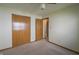 Bedroom with neutral carpet, a closet with wood sliding doors, and adjoining room at 1232 Severn Ct, Greenwood, IN 46142
