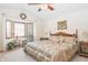 Inviting bedroom with bay windows, a ceiling fan, and a decorative wreath at 1232 Severn Ct, Greenwood, IN 46142
