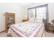 Cozy bedroom featuring a floral quilt, wood furnishings and natural light from a window at 1232 Severn Ct, Greenwood, IN 46142