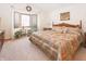 Inviting bedroom with bay windows, a ceiling fan, and a decorative wreath at 1232 Severn Ct, Greenwood, IN 46142