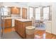 Eat-in kitchen includes wood cabinets, stainless steel refrigerator, and bay window seating at 1232 Severn Ct, Greenwood, IN 46142
