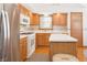 Cozy kitchen with wood cabinets, stainless steel refrigerator, and center island at 1232 Severn Ct, Greenwood, IN 46142