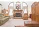 Bright living room featuring large windows flanking a brick fireplace and comfortable seating at 1232 Severn Ct, Greenwood, IN 46142