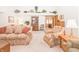 Cozy living room with patterned sofas, decorative shelving, and warm, neutral carpeting at 1232 Severn Ct, Greenwood, IN 46142