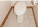 Close-up of a standard white toilet with a roll of toilet paper in a tiled bathroom at 1232 Severn Ct, Greenwood, IN 46142