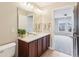 A well-lit bathroom features a double sink vanity and access to an adjacent bedroom at 13750 Hiatt Dr, Carmel, IN 46074