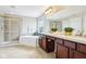 Luxurious bathroom featuring a soaking tub, glass shower, and dual vanity at 13750 Hiatt Dr, Carmel, IN 46074