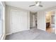 A bedroom with closet offers ample storage and a ceiling fan for a comfortable atmosphere at 13750 Hiatt Dr, Carmel, IN 46074