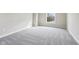 A bedroom with neutral paint, carpet, and a large bright window at 13750 Hiatt Dr, Carmel, IN 46074