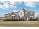 Beautiful two-story brick home featuring manicured landscaping and a charming blue front door at 13750 Hiatt Dr, Carmel, IN 46074