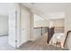 Bright hallway featuring neutral-colored walls, carpet, and wrought iron railing at 13750 Hiatt Dr, Carmel, IN 46074