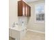 Well-lit laundry room featuring a utility sink, cabinetry, and a window for natural light at 13750 Hiatt Dr, Carmel, IN 46074