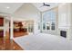 Open-concept living room showcasing hardwood floors, tall windows, and a modern fireplace at 13750 Hiatt Dr, Carmel, IN 46074