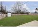 Fenced in backyard with newly installed lawn, shed, and exterior view of neighboring homes at 1611 Orchard Ln, Anderson, IN 46011