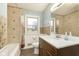Bathroom with tiled shower and walls, vanity with marble countertop, and tiled flooring at 1611 Orchard Ln, Anderson, IN 46011