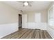 Bedroom showcasing a ceiling fan, wood-look flooring, neutral paint and large closet at 1611 Orchard Ln, Anderson, IN 46011