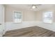 This bedroom features two windows for natural light, hard surface floors, and paneled wainscotting at 1611 Orchard Ln, Anderson, IN 46011