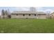 Exterior view of home with newly installed lawn, stone facade, and fenced in backyard at 1611 Orchard Ln, Anderson, IN 46011