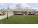Charming single-story home with stone facade, well-maintained lawn, and attached one-car garage at 1611 Orchard Ln, Anderson, IN 46011