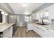 Modern kitchen features stainless steel appliances, white cabinets, and granite countertops at 1611 Orchard Ln, Anderson, IN 46011