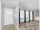 Bright living room featuring gray flooring, a front door, neutral walls, and plenty of natural light at 1611 Orchard Ln, Anderson, IN 46011