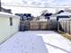 A large wooden fence surrounds this private, snow-covered backyard, providing privacy at 1640 Bellefontaine St, Indianapolis, IN 46202